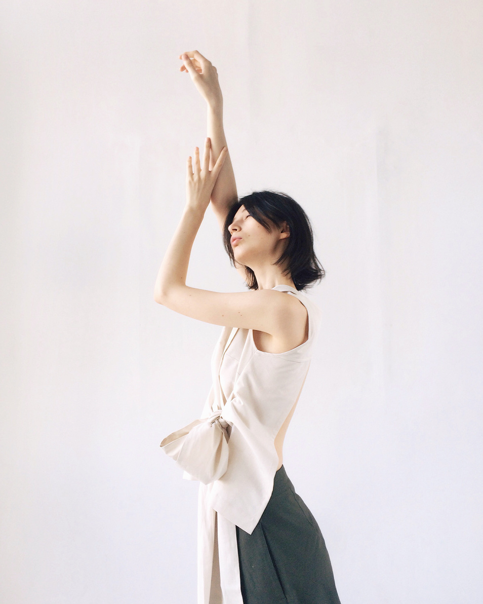 Women's Beige Sleeveless Blouse Raising Hands